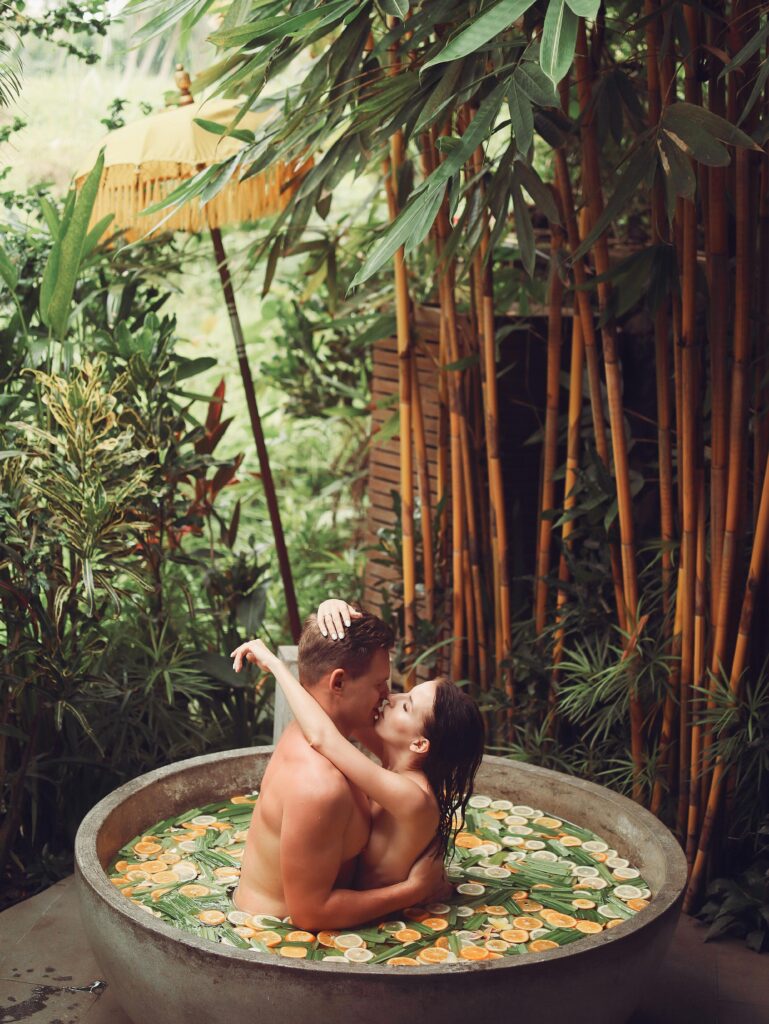 Couples intimacy retreat with spa featuring a romantic herbal bath surrounded by lush tropical greenery